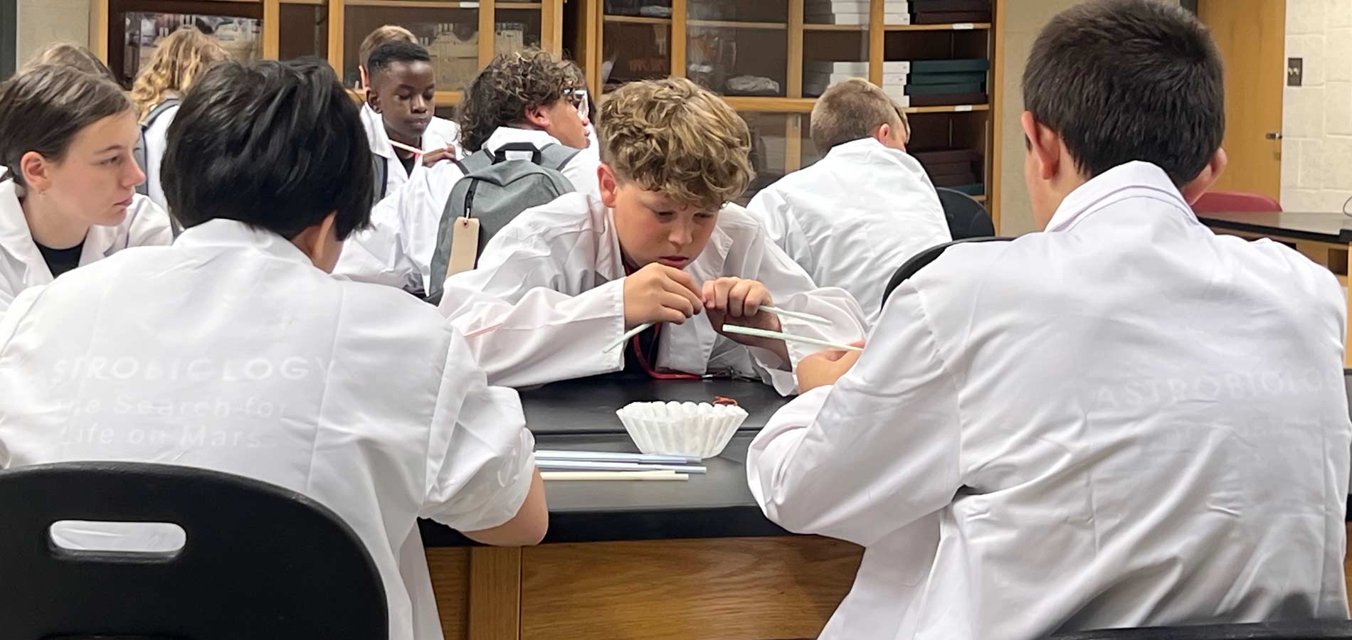 Students collaborated with their teams to design a protective system for an egg, symbolizing the astronauts. Each team was given an egg to safeguard using only straws, pipe cleaners, and coffee filters.